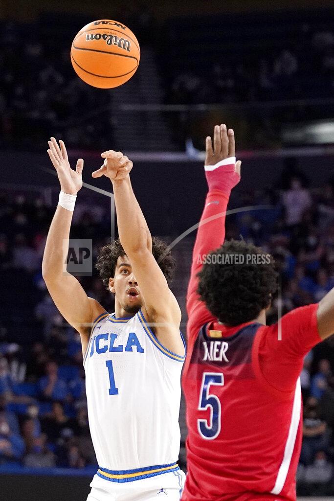 Mark J. Terrill UCLA guard Jules Bernard, left, shoots as Arizona guard Justin Kier defends during the second half of an NCAA college basketball game Tuesday, Jan. 25, 2022, in Los Angeles. (AP Photo/Mark J. Terrill)