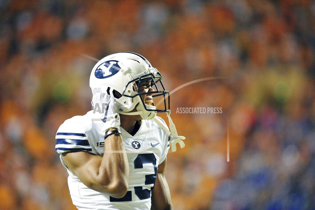 Scott Keller BYU's Micah Simon (13) unbuckles his helmet as the post game celebration begins following the Cougar's 26-23 overtime victory over UT in an NCAA football game Saturday September 7, 2019 in Knoxville, Tenn. (Scott Keller/The Daily Times via AP)