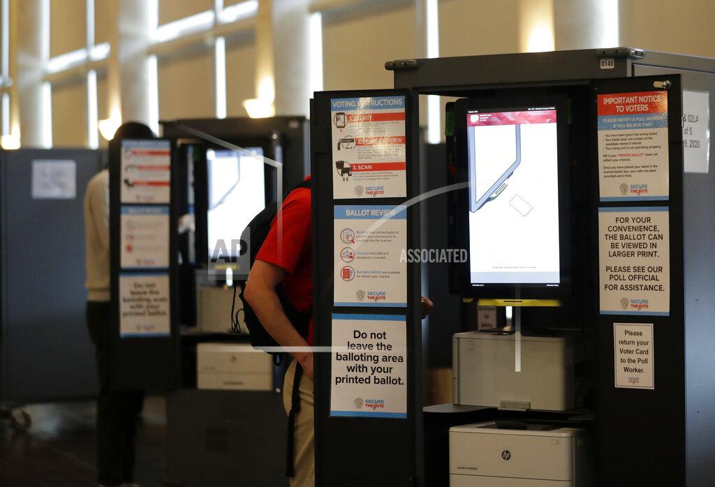 Brynn Anderson People vote at voting booths in the Georgia's primary election at Park Tavern on Tuesday, June 9, 2020, in Atlanta. (AP Photo/Brynn Anderson)