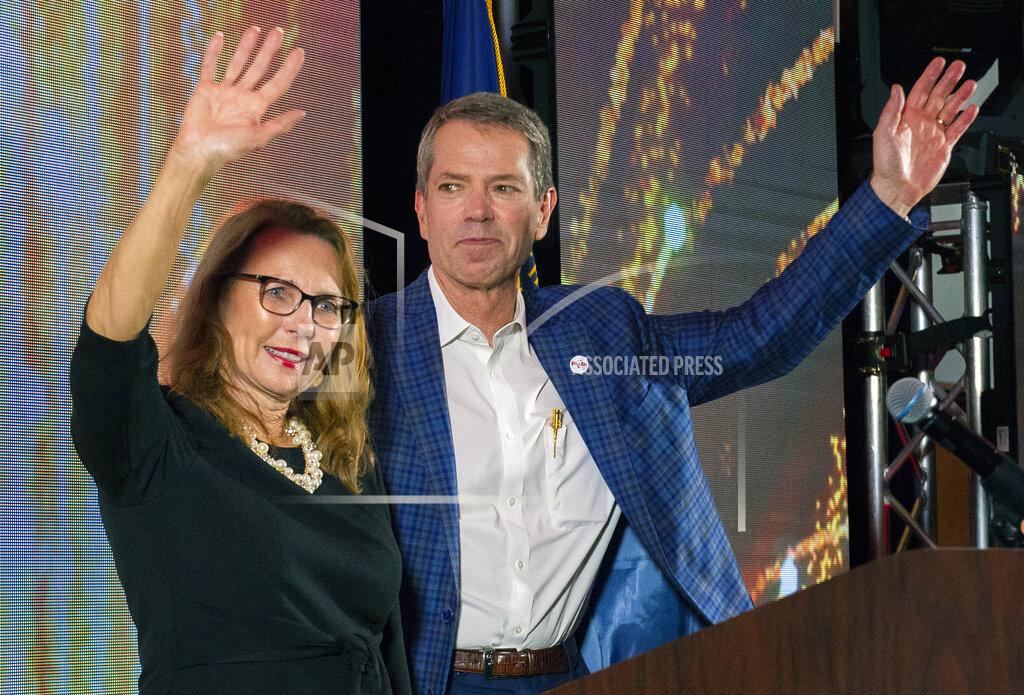 Kenneth Ferriera University of Nebraska Regent Jim Pillen, right, and his wife Suzanne Pillen wave to the crowd of supporters as he is named the winner of the Nebraska Republican gubernatorial primary during an election night party at the Embassy Suites on Tuesday, May 10, 2022, in Lincoln, Neb. (Kenneth Ferriera/Lincoln Journal Star via AP)