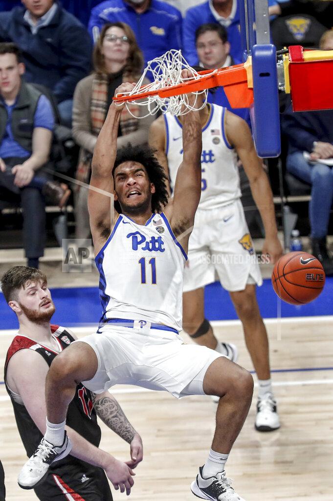 Keith Srakocic Pittsburgh's Justin Champagnie (11) dunks in front of Northern Illinois's Noah McCarty, left, to give Pitt the lead during the second half of an NCAA college basketball game, Monday, Dec. 16, 2019, in Pittsburgh. Pittsburgh won 59-50. (AP Photo/Keith Srakocic)