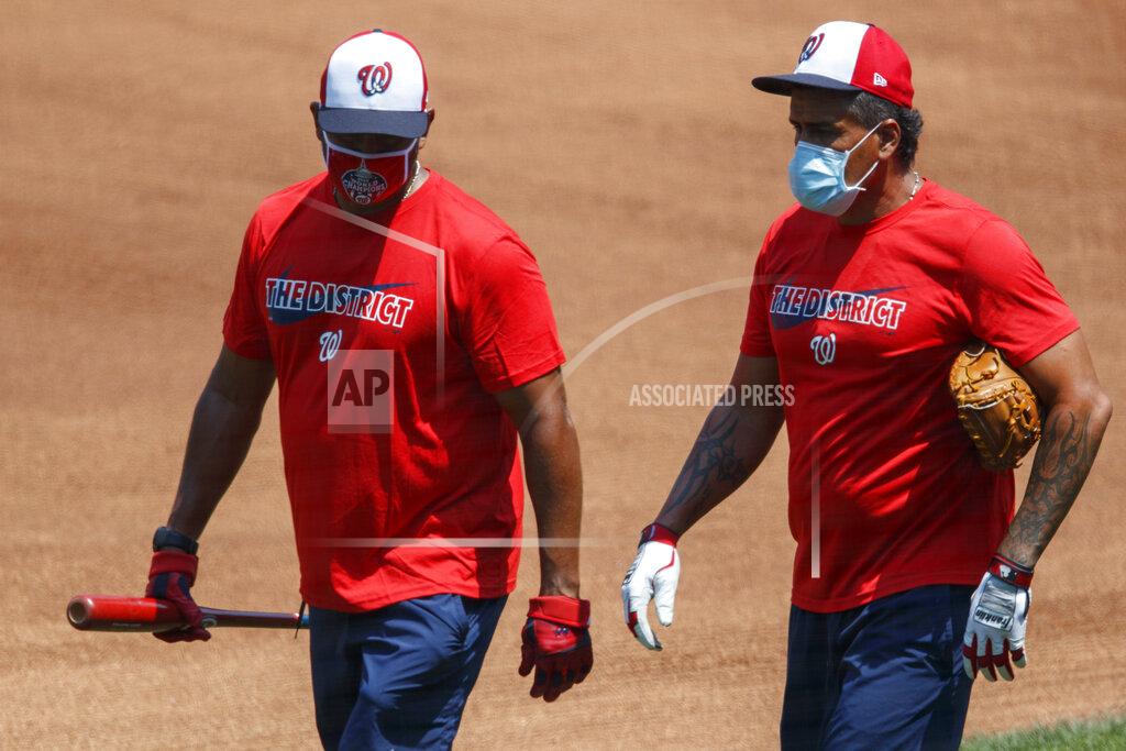 Carolyn Kaster Washington Nationals' manager Dave Martinez, left, and bullpen coach Henry Blanco walk together during a baseball training camp workout at Nationals Stadium, Sunday, July 5, 2020, in Washington. (AP Photo/Carolyn Kaster)