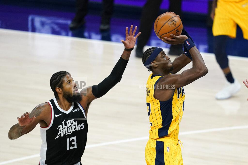Darron Cummings Indiana Pacers' Caris LeVert (22) shoots against Los Angeles Clippers' Paul George (13) during the second half of an NBA basketball game, Tuesday, April 13, 2021, in Indianapolis. (AP Photo/Darron Cummings)