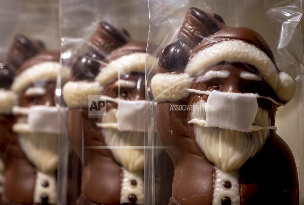 Michael Probst A confectioner offers chocolate Santa Claus wearing a face mask, displayed in the window of a shop in central Frankfurt, Germany, Sunday, Nov. 22, 2020. (AP Photo/Michael Probst)