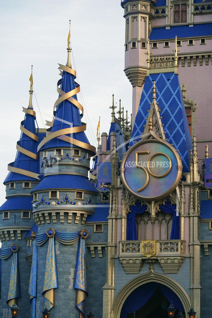 John Raoux The newly painted Cinderella Castle at the Magic Kingdom at Walt Disney World is seen with the the crest to celebrate the 50th anniversary of the theme park Monday, Aug. 30, 2021, in Lake Buena Vista, Fla. (AP Photo/John Raoux)