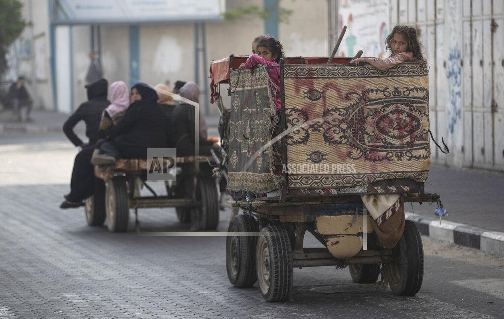 Khalil Hamra Palestinians flee their homes after overnight Israeli heavy missile strikes on their neighborhoods in the outskirts of Gaza City, Friday, May 14, 2021. (AP Photo/Khalil Hamra)