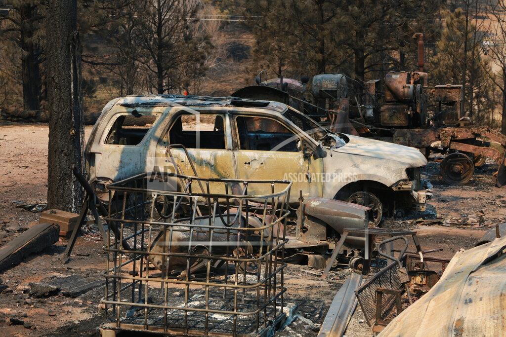 Cedar Attanasio A burned car and piece of machinery are seen following a wildfire near Las Vegas, New Mexico, on Monday, May 2, 2022. Wind-whipped flames are marching across more of New Mexico's tinder-dry mountainsides, forcing the evacuation of area residents and dozens of patients from the state's psychiatric hospital as firefighters scramble to keep new wildfires from growing. The big blaze burning near the community of Las Vegas has charred more than 217 square miles. (AP Photo/Cedar Attanasio)