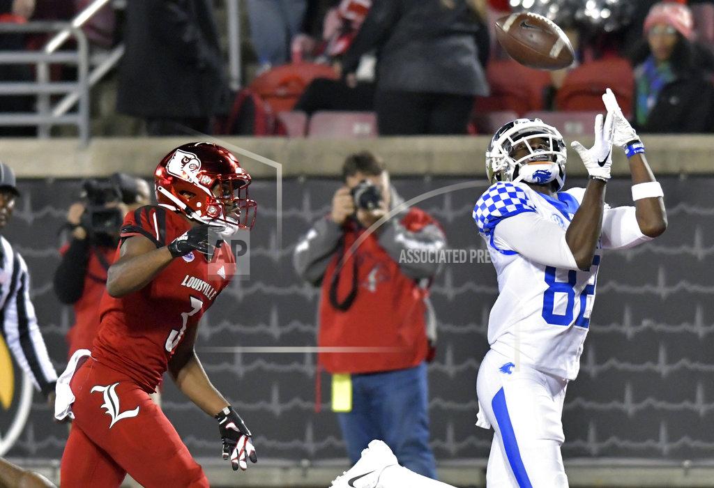 Timothy D. Easley Kentucky wide receiver Josh Ali (82) reaches for a pass ahead of the defense of Louisville cornerback Cornelius Sturghill (3) during the second half of an NCAA college football game in Louisville, Ky., Saturday, Nov. 24, 2018. Kentucky won 56-10. (AP Photo/Timothy D. Easley)