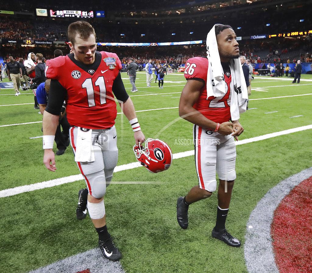 Curtis Compton Georgia quarterback Jake Fromm and defensive back Tyrique McGhee walk off the field after the team's 28-21 loss to Texas in the Sugar Bowl NCAA college football game Tuesday, Jan. 1, 2019, in New Orleans. (Curtis Compton/Atlanta Journal Constitution via AP)