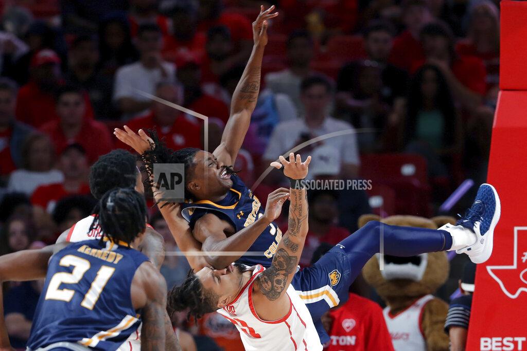Michael Wyke Northern Colorado guard Langston Reynolds, top right, falls into Houston guard Emanuel Sharp, bottom right, after a layup during the second half of an NCAA college basketball game Monday, Nov. 7, 2022, in Houston. (AP Photo/Michael Wyke)