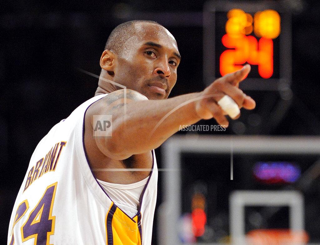 Mark J. Terrill FILE - In this June 7, 2009, file photo, Los Angeles Lakers guard Kobe Bryant (24) points to a player behind him after making a basket in the closing seconds against the Orlando Magic in Game 2 of the NBA basketball finals, in Los Angeles. Kobe Bryant, Tim Duncan and Kevin Garnett. Each was an NBA champion, an MVP, an Olympic gold medalist, annual locks for All-Star and All-Defensive teams. And now, the ultimate honor comes their way: On Saturday night, May 15, 2021, in Uncasville, Connecticut, they all officially become members of the Naismith Memorial Basketball Hall of Fame. (AP Photo/Mark J. Terrill, File)