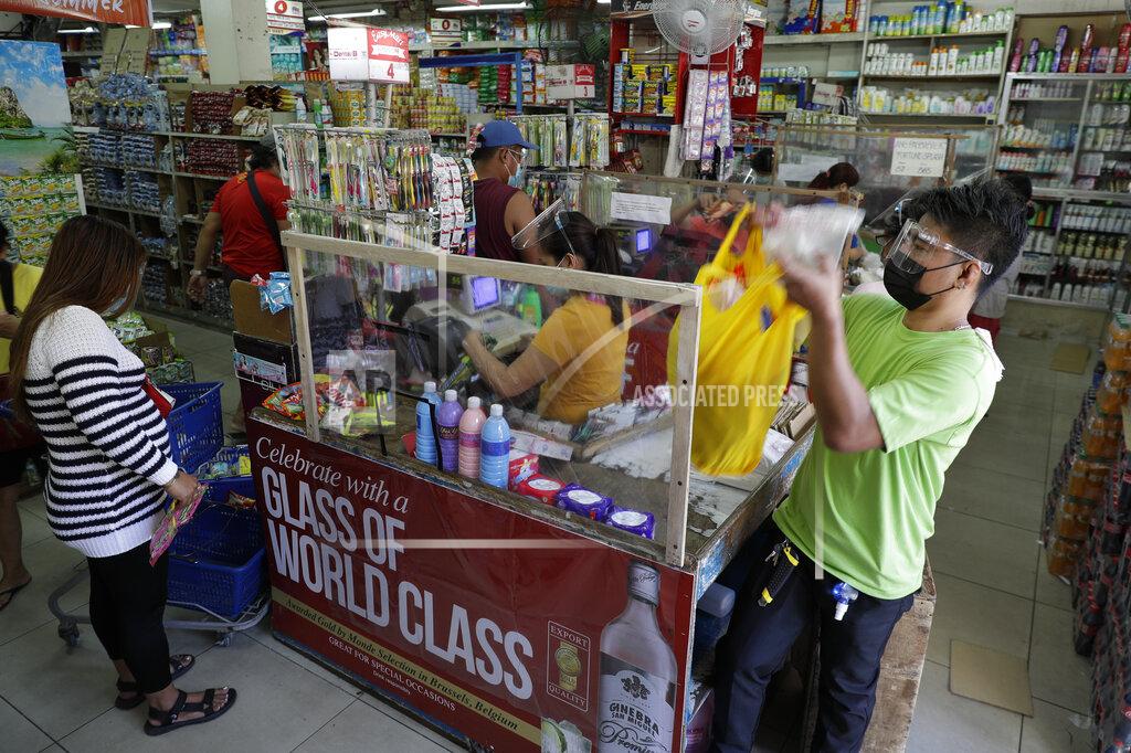 Aaron Favila People wearing face masks and face shields to prevent the spread of the coronavirus buy at a grocery in Quezon city, Philippines as they prepare for a stricter lockdown on Sunday March 28, 2021. The government will start stricter lockdown measures next week as the country struggles to control an alarming surge in COVID-19 cases. (AP Photo/Aaron Favila)