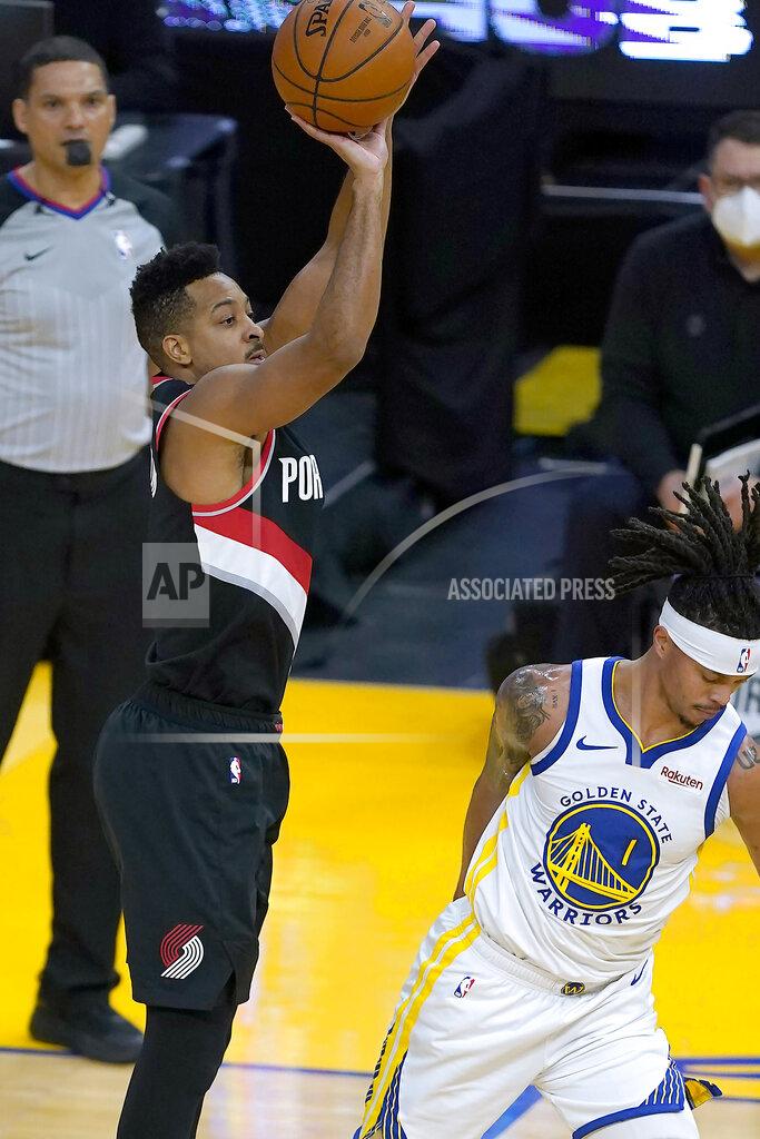 Tony Avelar Portland Trail Blazers guard CJ McCollum (3) takes a 3-point shot over Golden State Warriors guard Damion Lee (1) during the first half of an NBA basketball game in San Francisco, Friday, Jan. 1, 2021. (AP Photo/Tony Avelar)