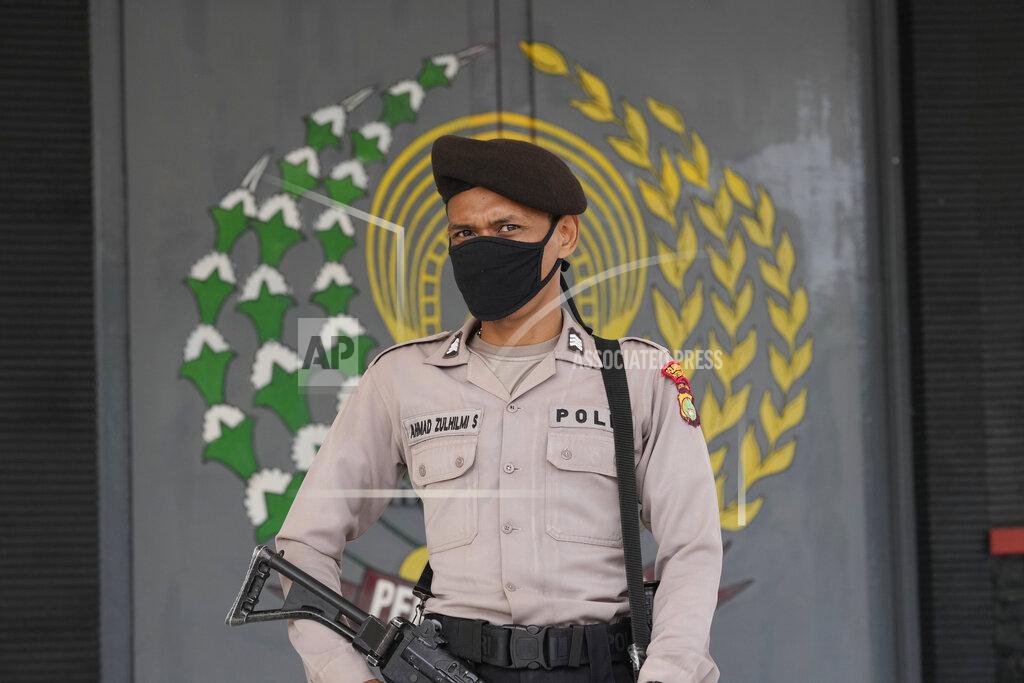 Dita Alangkara A police officers stands guard at the main entrance gate of Tangerang prison in Tangerang on the outskirts of Jakarta, Indonesia, Wednesday, Sept. 8, 2021. A massive fire raged through the overcrowded prison early Wednesday, killing a number of inmates. (AP Photo/Dita Alangkara)