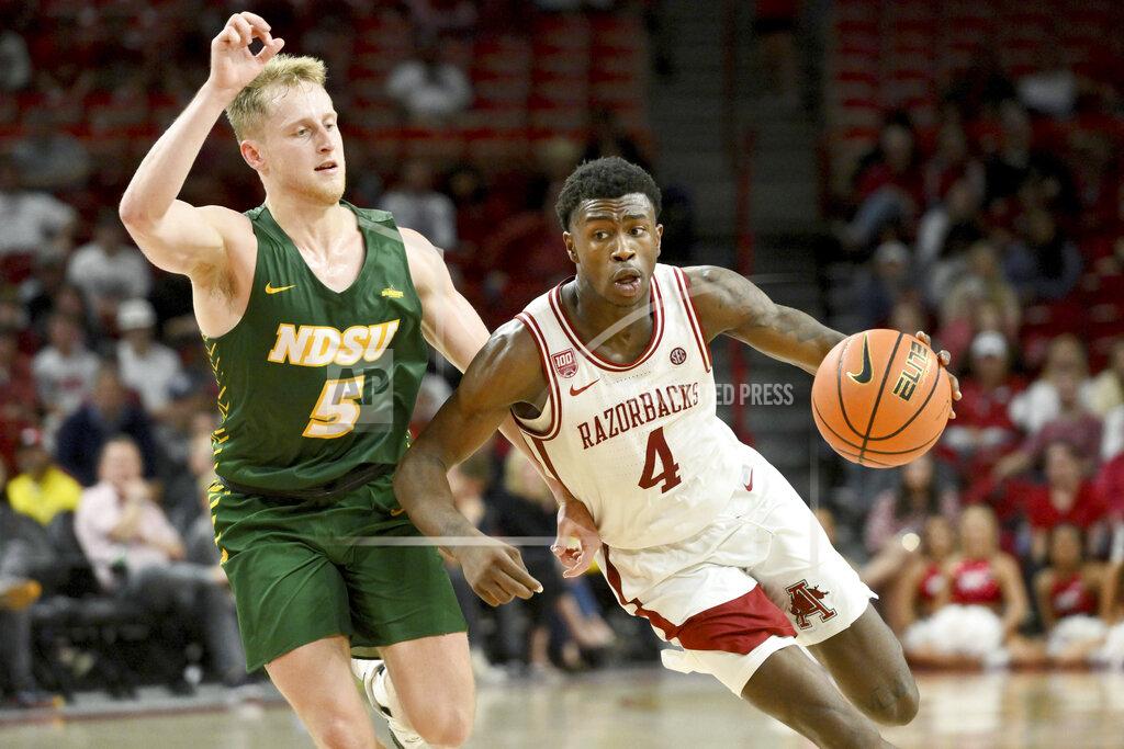 Michael Woods Arkansas guard Davonte Davis (4) drives past North Dakota State guard Luke Yoder (5) during the second half of an NCAA college basketball game Monday, Nov. 7, 2022, in Fayetteville, Ark. (AP Photo/Michael Woods)