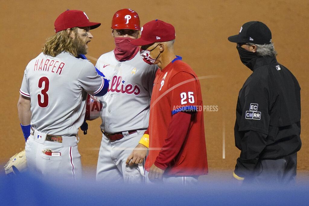John Minchillo Philadelphia Phillies' Bryce Harper talks next to manager Joe Girardi (25) after being thrown out of the baseball game by umpire Roberto Ortiz during the fifth inning against the New York Mets, Saturday, Sept. 5, 2020, in New York. (AP Photo/John Minchillo)