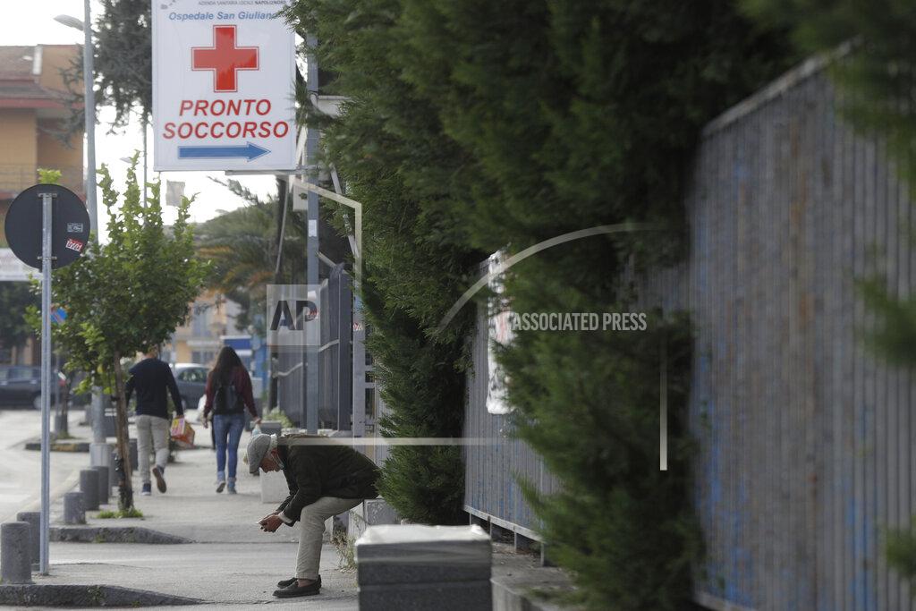 Gregorio Borgia A man waits outside the San Giuliano hospital in Giugliano in the outskirts of Naples, Italy, Saturday, Nov. 14, 2020. The pandemic has heightened the urgency of the plight of those seeking medical care in public hospitals in Italy’s economically under-developed south. (AP Photo/Gregorio Borgia)