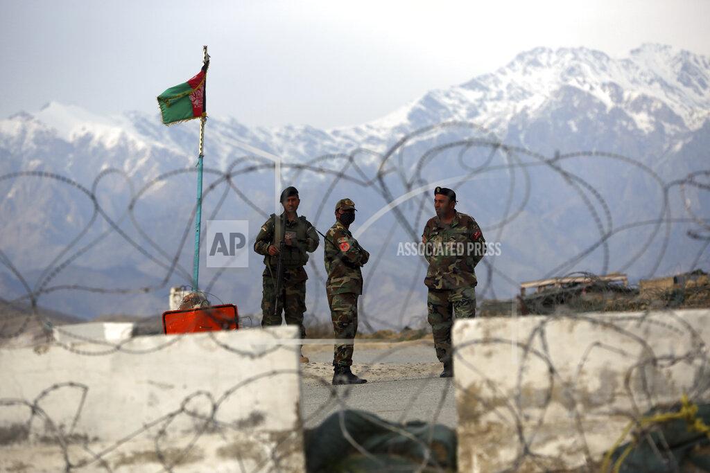 Afghan National Army soldiers stand guard at a checkpoint near the Bagram base in northern Kabul, Afghanistan, Wednesday, April 8, 2020. An Afghan official said Wednesday that the country has released 100 Taliban prisoners from Bagram, claiming they are part of 5,000 detainees who are to be freed under a deal between insurgents and U.S. But the Taliban says they have yet to verify those released were on the list they had handed over to Washington during negotiations. (AP Photo/Rahmat Gul)