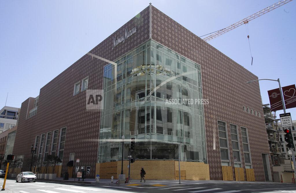 Ben Margot A person walks in front of a boarded up Neiman Marcus department store on Wednesday, May 27, 2020, in San Francisco. While much of California moves swiftly to reopen things like hair salons under California Gov. Gavin Newsom's guidance, the San Francisco Bay Area is continuing to keep the brakes on. Some health officials are questioning whether the state is taking enough time to assess the effects of reopening things like stores before jumping ahead to broader re-openings, risking a surge in infections. (AP Photo/Ben Margot)