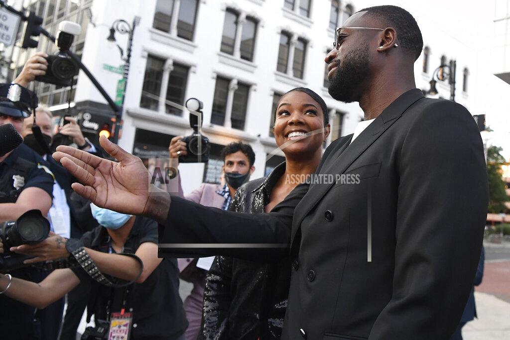 Jessica Hill Dwyane Wade and Gabrielle Union greet fans as they arrive for the 2021 Basketball Hall of Fame Enshrinement ceremony, Saturday, Sept. 11, 2021, in Springfield, Mass. (AP Photo/Jessica Hill)