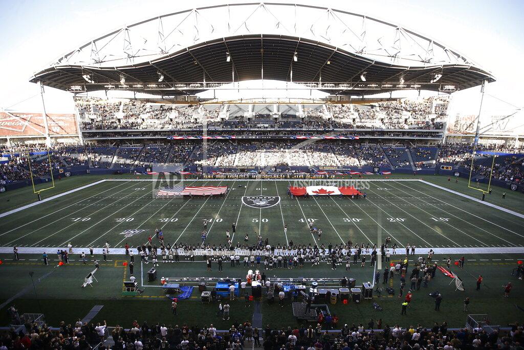 John Woods U.S. and Canadian flags are presented on the field before an NFL preseason football game between the Green Bay Packers and the Oakland Raiders on Thursday, Aug. 22, 2019, in Winnipeg, Manitoba. (John Woods/The Canadian Press via AP)