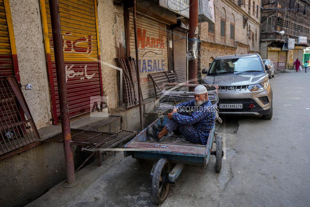 Mukhtar Khan An elderly man rests in a handcart parked in front of the closed shops in Srinagar, Indian controlled Kashmir, Thursday, May 26, 2022. Police in disputed Kashmir arrested at least 10 youths during overnight raids following an anti-India protest that erupted as an Indian court sentenced a prominent Kashmiri pro-independence leader to life in prison, officials said Thursday. (AP Photo/Mukhtar Khan)