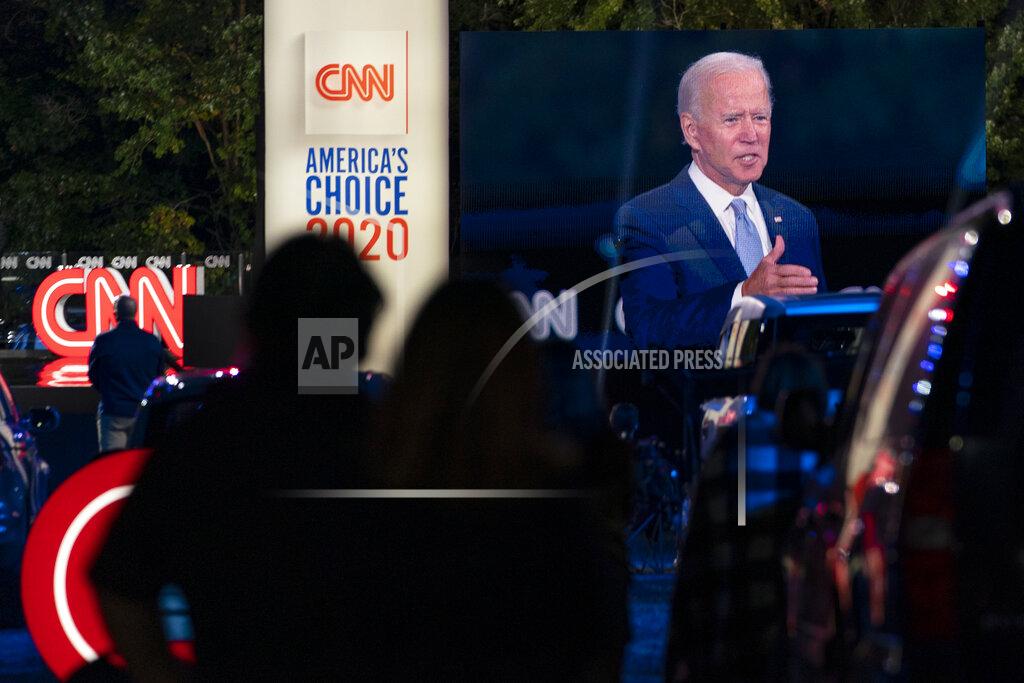 Carolyn Kaster Audience members watch from their cars as Democratic presidential candidate former Vice President Joe Biden, seen on a monitor, speaks during a CNN town hall in Moosic, Pa., Thursday, Sept. 17, 2020. (AP Photo/Carolyn Kaster)