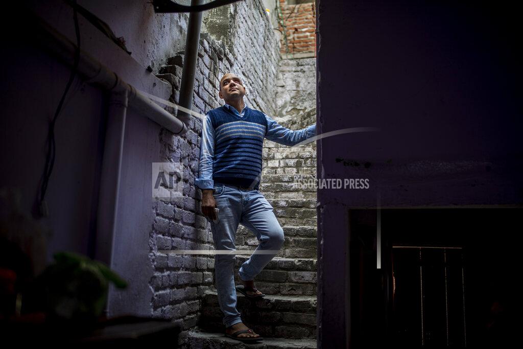 Altaf Qadri Muhammad Nasir Khan, who was shot by a Hindu mob during the February 2020 communal riots, is seen inside his home in North Ghonda, one of the worst riot affected neighborhood, in New Delhi, India, Friday, Feb. 19, 2021. As the first anniversary of bloody communal riots that convulsed the Indian capital approaches, Muslim victims are still shaken and struggling to make sense of their struggle to seek justice. (AP Photo/Altaf Qadri)