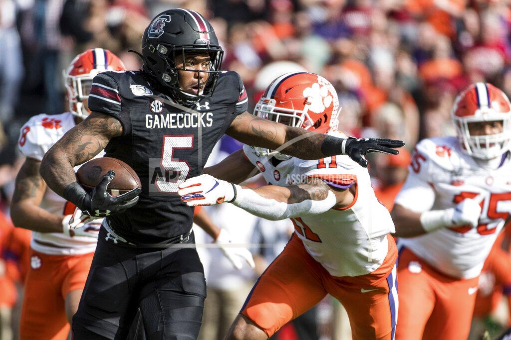 Sean Rayford South Carolina running back Rico Dowdle (5) carries the ball against Clemson linebacker Isaiah Simmons (11) during the first half of an NCAA college football game Saturday, Nov. 30, 2019, in Columbia, S.C. (AP Photo/Sean Rayford)