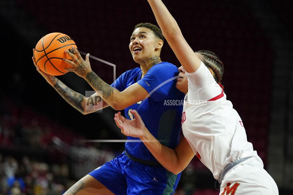 Julio Cortez Florida Gulf Coast guard Kierstan Bell, left, goes up for a basket against Maryland forward Mimi Collins during the first half of a college basketball game in the second round of the NCAA tournament, Sunday, March 20, 2022, in College Park, Md. (AP Photo/Julio Cortez)
