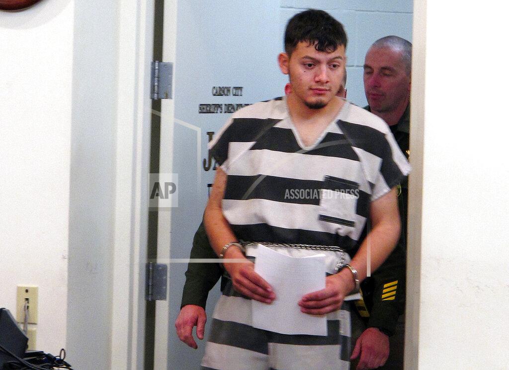Scott Sonner FILE - In this Jan. 24, 2019, file photo, Wilber Ernesto Martinez-Guzman, 19, of El Salvador, is escorted into the courtroom for his initial appearance in Carson City Justice Court in Carson City, Nev. The Nevada Supreme Court struck down a deadline Friday, April 9, 2021, that a district judge set later this month for the Salvadoran immigrant's lawyers to file a motion claiming he's intellectually disabled and therefore can't be executed if convicted of murdering a Reno couple and two other woman. (AP Photo/Scott Sonner, File)