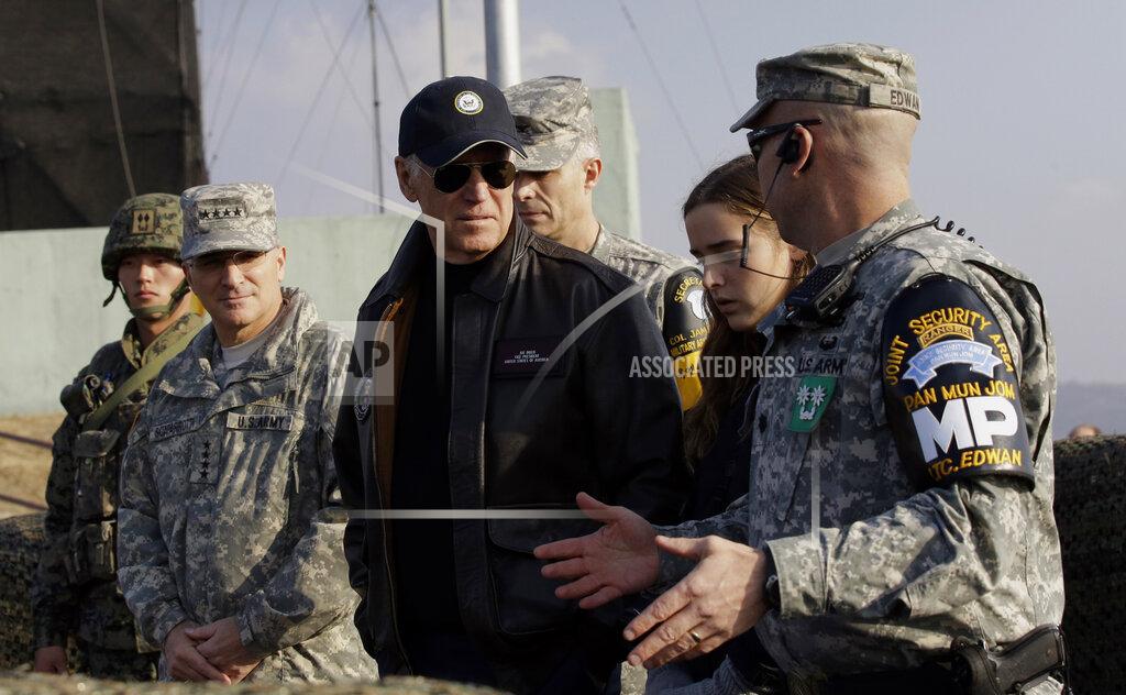 Lee Jin-Man FILE - Vice President Joe Biden, center, is briefed by Lt. Col. Daniel Edwan, the commander of the JSA Security Battalion from Observation Post Ouellette during his tour of the Demilitarized Zone (DMZ), near the border village of Panmunjom, which has separated the two Koreas since the Korean War, South Korea, Dec. 7, 2013. When the U.S. and South Korean leaders meet Saturday, May 21, 2022, North Korea’s nuclear weapons and missile program, already a major focus, may receive extra attention if intelligence predictions of an imminent major weapons demonstration by the North, which is struggling with a COVID-19 outbreak, are right. (AP Photo/Lee Jin-man, File-Pool)