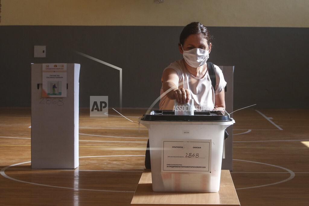 Boris Grdanoski A woman wearing a face mask casts her ballot at a polling station in Skopje, North Macedonia on Wednesday, July 15, 2020. Voters in North Macedonia were heading to polls early on Wednesday in the country's general election despite an alarming spike in coronavirus cases in the tiny Balkan nation. (AP Photo/Boris Grdanoski)