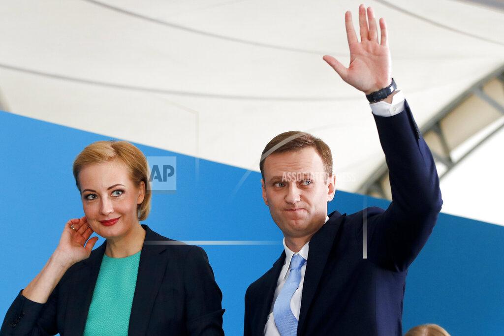 Pavel Golovkin FILE - In this Dec. 24, 2017, file photo, Russian opposition leader Alexei Navalny and his wife Yulia attend a meeting where he was nominated for the presidential election race in Moscow, Russia. Navalny sought to challenge President Vladimir Putin in the 2018 election, but was barred from running by one of his convictions. Navalny is an anti-corruption campaigner and the Kremlin’s fiercest critic. (AP Photo/Pavel Golovkin, File)