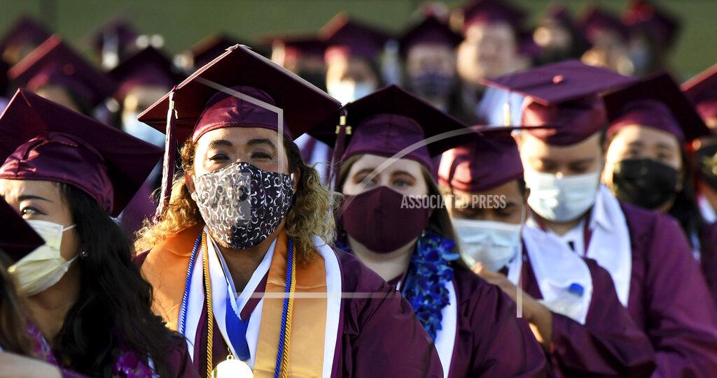 Keith Birmingham Students wearing masks listen to speakers during the Mount Sac graduation at Hilmer Lodge Stadium in Walnut, Calif., Friday, June 11, 2021. (Keith Birmingham/The Orange County Register via AP)