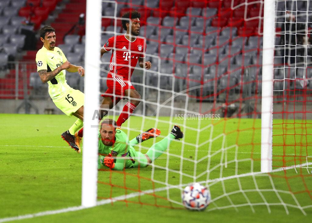 Matthias Schrader Bayern Munich's Kingsley Coman, centre, kicks the ball past Atletico Madrid's Stefan Savic, left, and goalkeeper Jan Oblak to score his team's first goal during the Champions League Group A soccer match between Bayern Munich and Atletico Madrid at the Allianz Arena in Munich, Germany, Wednesday, Oct. 21, 2020. (AP Photo/Matthias Schrader,Pool)
