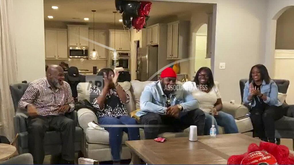 Uncredited In this still image from video provided by the NFL, Andrew Thomas, center, smiles during the NFL football draft Thursday, April 23, 2020. The New York Giants selected Thomas with the fourth pick. (NFL via AP)
