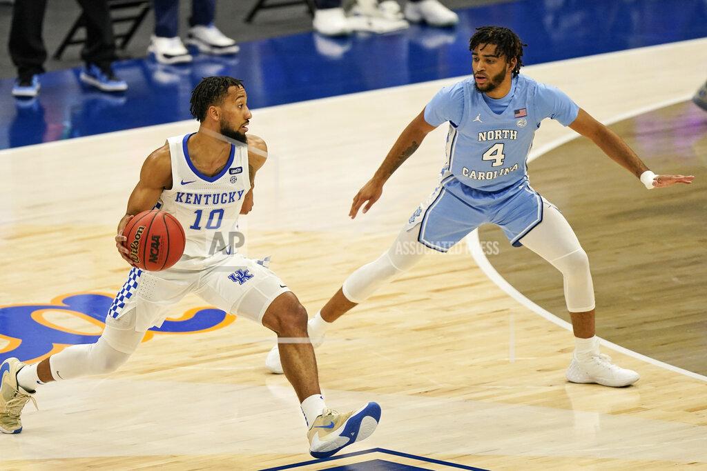 Tony Dejak Kentucky's Davion Mintz (10) drive past North Carolina's R.J. Davis (4) in the first half of an NCAA college basketball game, Saturday, Dec. 19, 2020, in Cleveland. (AP Photo/Tony Dejak)
