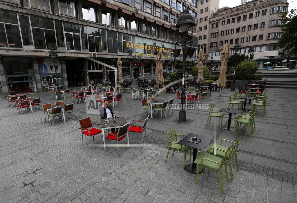 Darko Vojinovic A customer seats outside a cafe with tables to respect the two meters social distancing because of the coronavirus pandemic in Belgrade, Serbia, Monday, May 4, 2020. The Balkan country has started easing the measures, but experts have warned that the situation is still volatile. (AP Photo/Darko Vojinovic)
