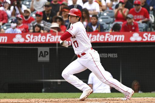 Los Angeles Angels designated hitter Shohei Ohtani hits a single in the sixth inning of a baseball game against the Seattle Mariners, Sunday, Sept. 26, 2021, in Anaheim, Calif. The Mariners won 5-1. (AP Photo/Michael Owen Baker)