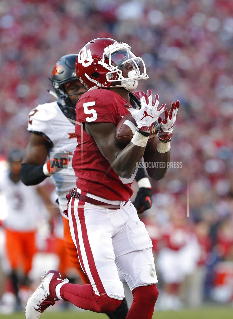 Alonzo Adams Oklahoma wide receiver Marquise Brown (5) makes a catch ahead of Oklahoma State cornerback Tanner McCalister (2) in the second quarter of an NCAA college football game in Norman, Okla., Saturday, Nov. 10, 2018. (AP Photo/Alonzo Adams)
