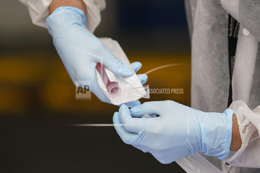 Frank Franklin Ii A Medical Assistant administers a Covid test as part of plans by the Metropolitan Transportation Authority to test workers Tuesday, Oct. 27, 2020, at the Grand Avenue Bus Depot in New York. (AP Photo/Frank Franklin II)