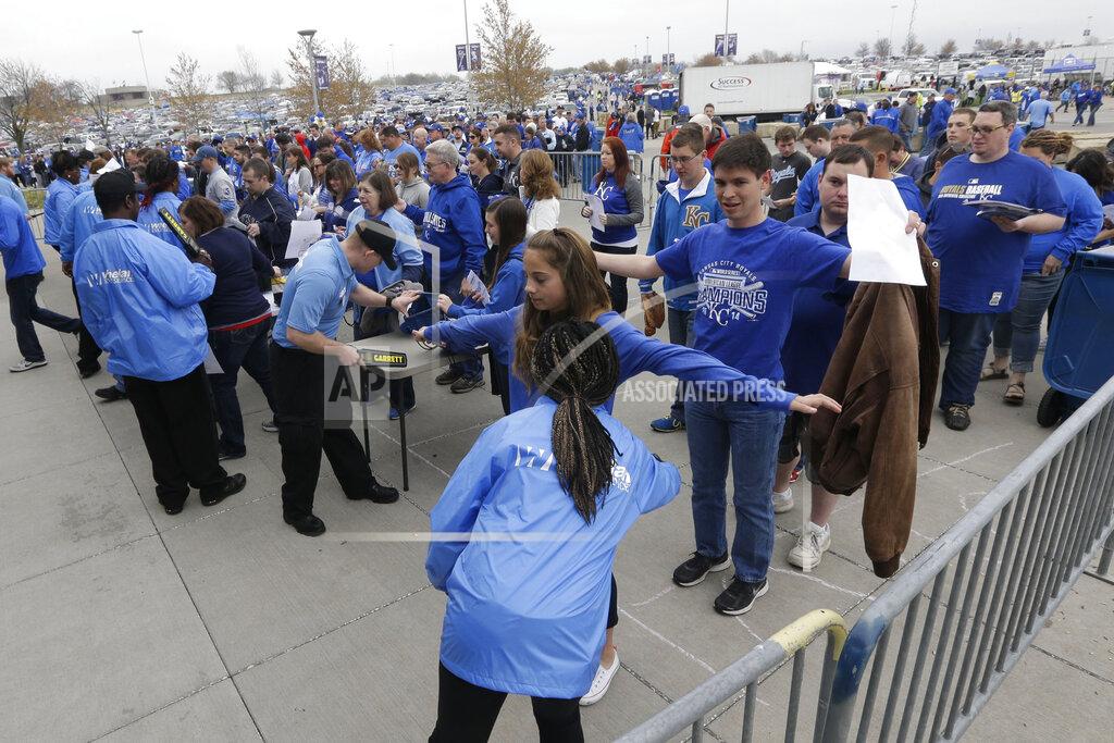 Orlin Wagner FILE - In this April 6, 2015, file photo, security wands fans before an opening day baseball game between the Chicago White Sox and Kansas City Royals at Kauffman Stadium in Kansas City, Mo. The metal detectors that greet sports fans at the gates might soon be accompanied by thermal body scanners, in the gargantuan task of better protecting venues from virus spread in order to bring the games back for in-person viewing. (AP Photo/Orlin Wagner, File)