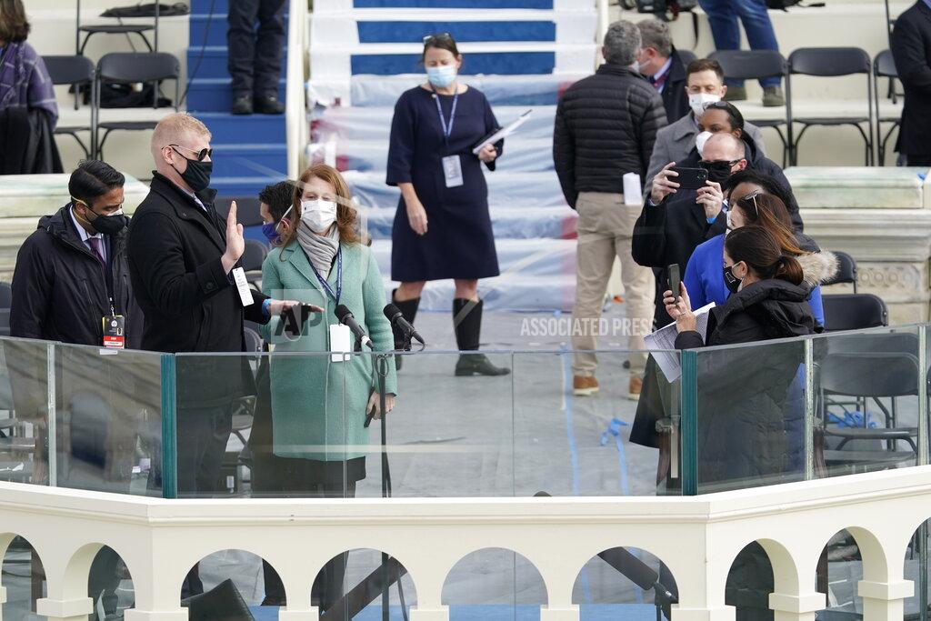 Patrick Semansky A stand-in for President-elect Joe Biden is sworn in on the podium, as a stand-in for Jill Biden looks on, during a rehearsal for the 59th Presidential Inauguration at the U.S. Capitol in Washington, Monday, Jan. 18, 2021. (AP Photo/Patrick Semansky, Pool)