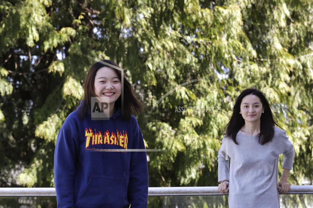Elaine Thompson Jodie Chen, right, and her daughter, Mandy Luo, pose for a portrait at their home in Issaquah, Wash., on Monday, April 13, 2020. After being away from her daughter for three years, Chen arrived days earlier from China and is self-quarantining at home out of an abundance of caution for the COVID-19 coronavirus. The family is waiting for husband and father Daniel Hsu to be allowed to leave China and join them in the U.S. (AP Photo/Elaine Thompson)
