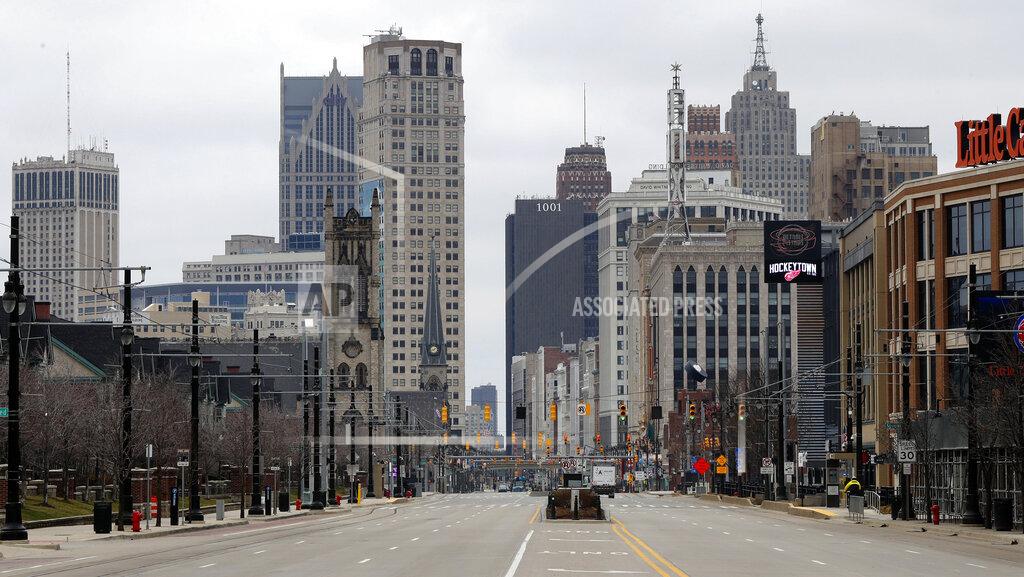 Paul Sancya In this March 24, 2020 file photo, Woodward Avenue is shown nearly empty in Detroit. Before the coronavirus showed up, downtown Detroit was returning to its roots as a vibrant city center, motoring away from its past as the model of urban ruin. Now, with the coronavirus forcing many office workers to their homes in the suburbs, those who remain wonder if revitalization will ever return. (AP Photo/Paul Sancya)