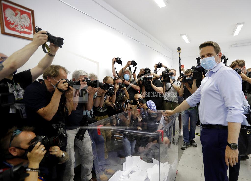 Petr David Josek Presidential candidate Rafal Trzaskowski casts his vote during presidential election in Warsaw, Poland, Sunday, June 28, 2020. The election will test the popularity of incumbent President Andrzej Duda who is seeking a second term and of the conservative ruling party that backs him. (AP Photo/Petr David Josek)