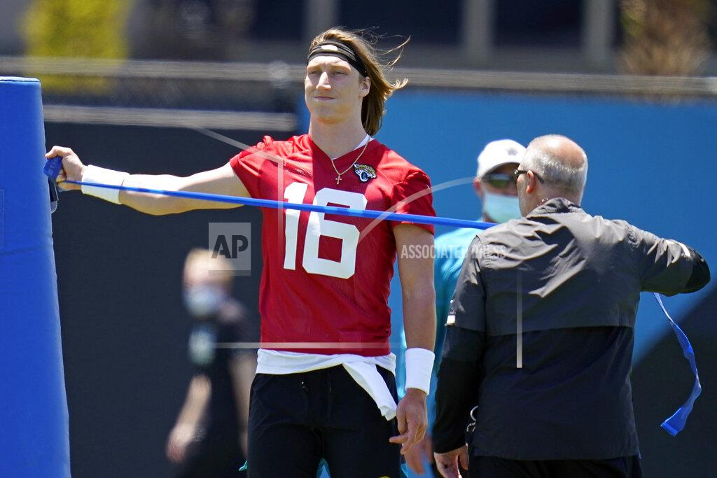 John Raoux Jacksonville Jaguars quarterback Trevor Lawrence (16) stretches out during an NFL football rookie minicamp, Saturday, May 15, 2021, in Jacksonville, Fla. (AP Photo/John Raoux)