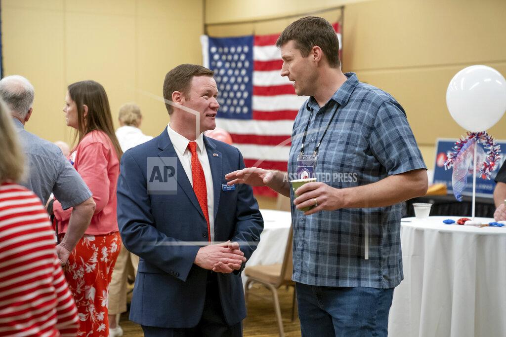Glen Stubbe GOP candidate for attorney general Doug Wardlow, left, speaks with a person during the first day of the Minnesota State Republican Convention, Friday, May 13, 2022, at the Mayo Civic Center in. Rochester, Minn. (Glen Stubbe/Star Tribune via AP)