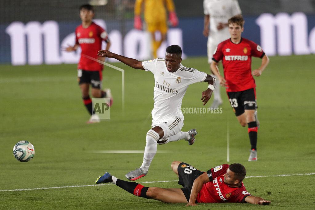 Bernat Armangue Real Madrid's Vinicius Junior, right, fights for the ball with Mallorca's Aleksandar Sedlar during the Spanish La Liga soccer match between Real Madrid and Mallorca at Alfredo di Stefano stadium in Madrid, Spain, Wednesday, June 24, 2020. (AP Photo/Bernat Armangue)